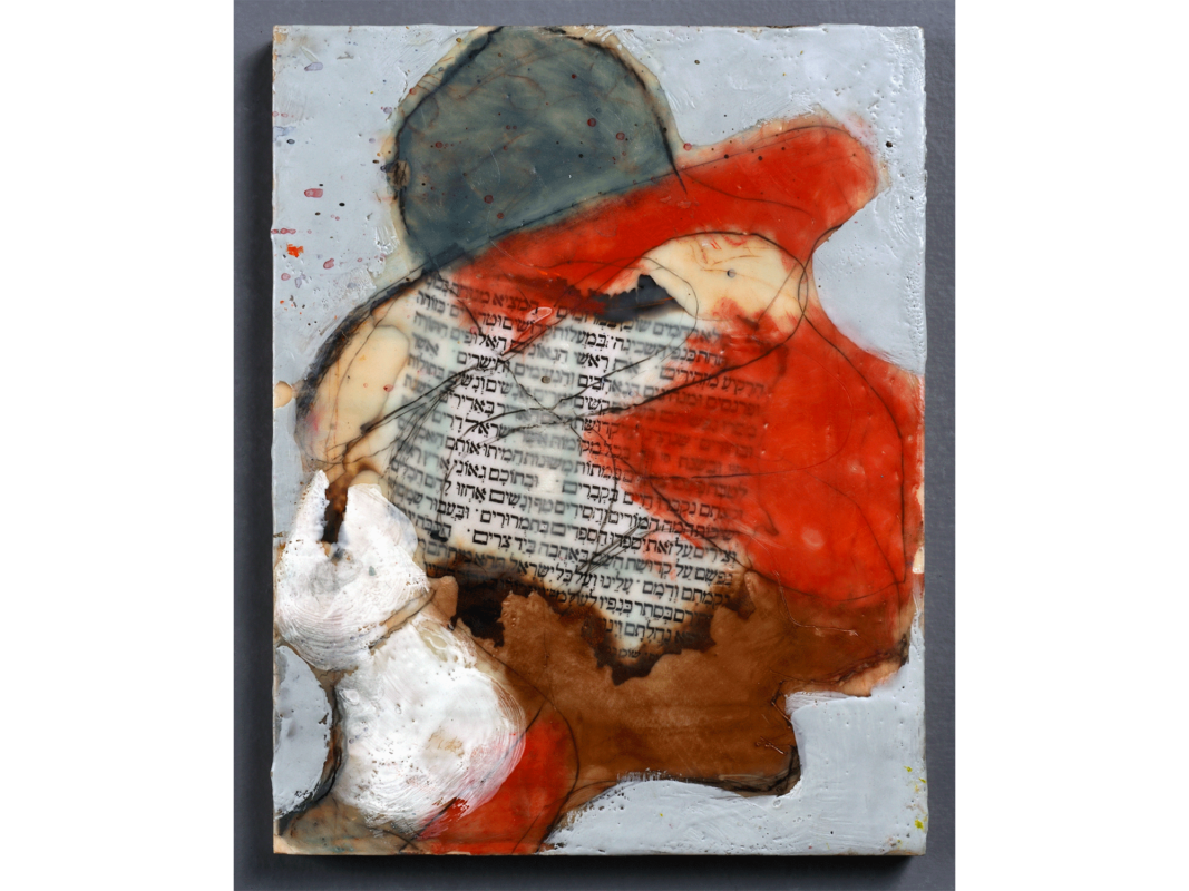 The artwork titled "Rahamim" was created in 2019 by Peter Sprung. The image is an abstract profile of a man's head, where large swaths of white, biege, brown, red, and gray paint create the borders of the man's face. The central element is a Hebrew text, embedded within a field of colors. Random black lines swirl about over the text and large blobs of color. The artwork is encaustic on wood, 12 inches by 12 inches.